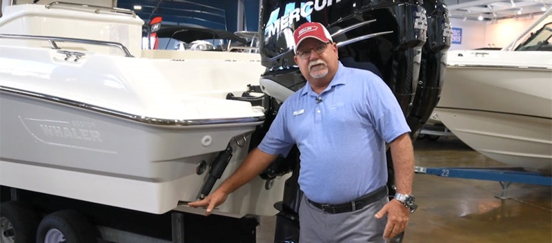Captain Keith standing beside a trim tab on a boat