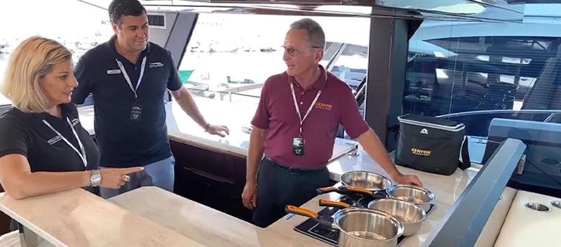 Three people aboard a Galeon Yacht using Kenyon Cookware