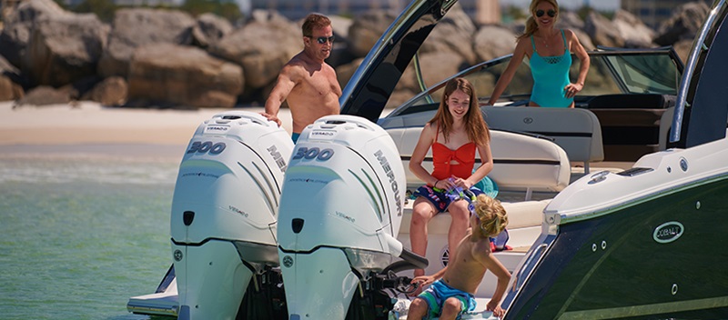 Owners of an outboard Cobalt on the water during the summer.