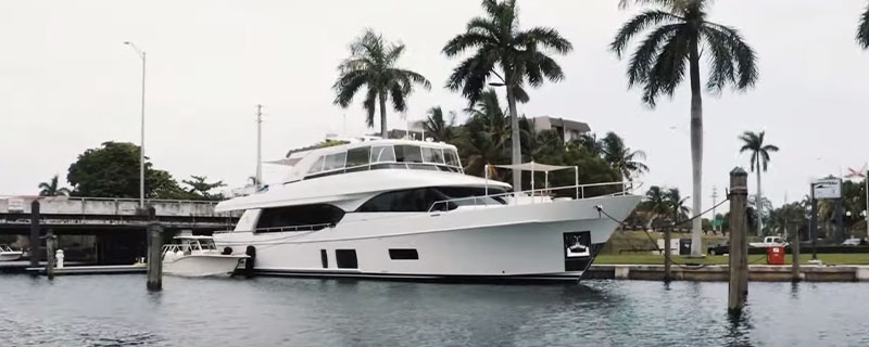 Ocean Alexander Yacht in the water in front of palm trees