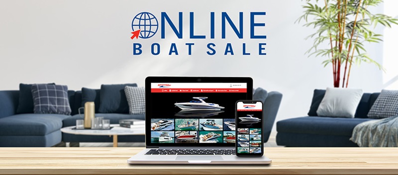 A laptop showing the MarineMax Online Boat Sale