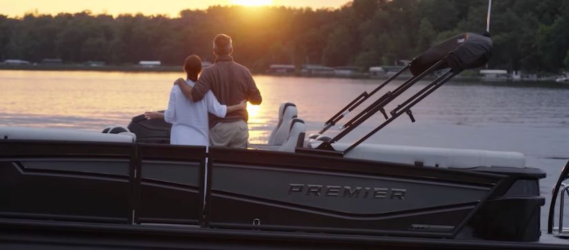 A man and woman on a Premier at sunset.