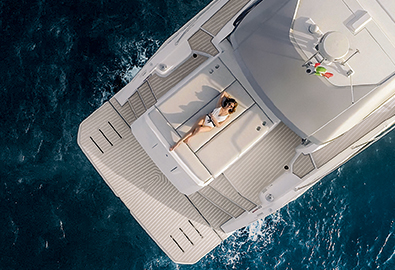 Lady laying on sunpad of a Yacht