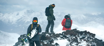 three people snowboarding