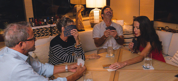 people playing games at a table on a boat