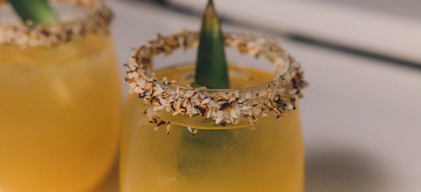 orange yellow cocktail with mint leaf