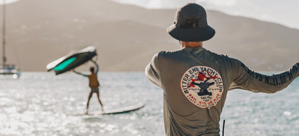 man with bitter end yacht club on back of tshirt looking at the water