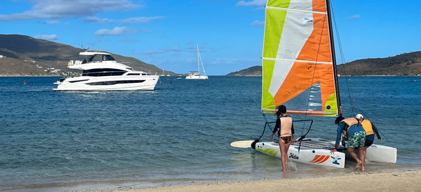 wind surfing board on the water with charter in distance