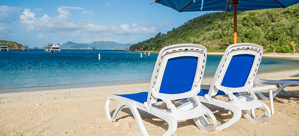 Chairs on a beach in the BVI overlooking the water
