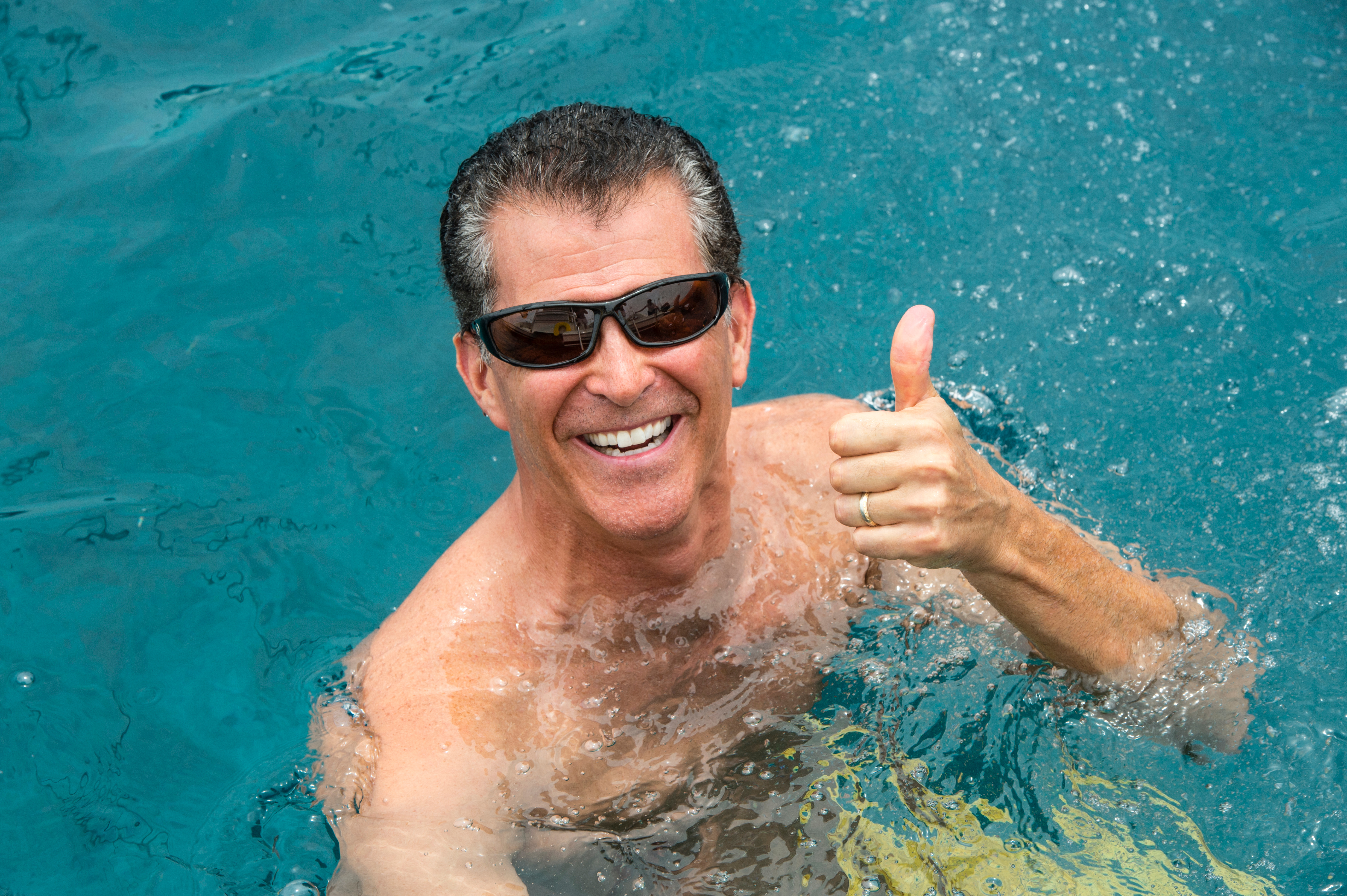 man smiling and giving the s up