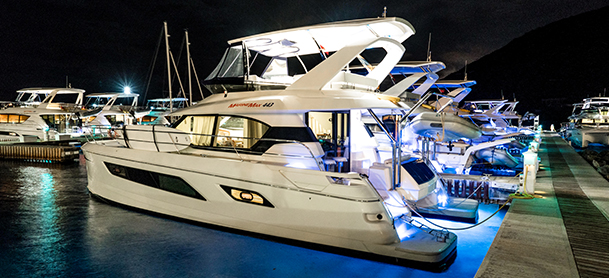 Power catamarans lit up at night on dock