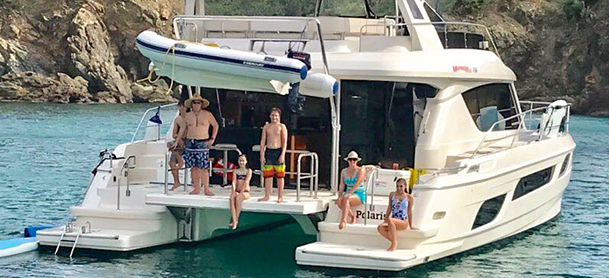 People on back of power catamaran