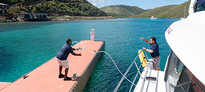 Vacations team members tying a knot at the dock