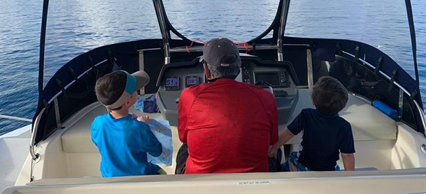 A man boating with two boys