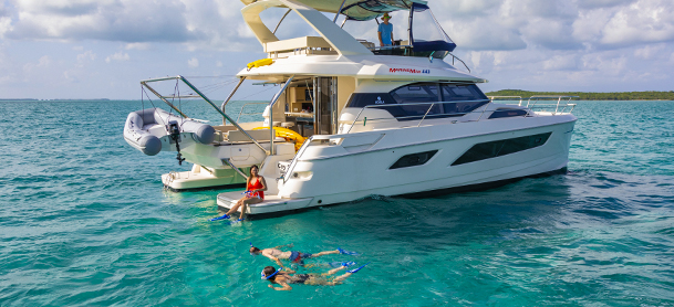 People snorkeling in the water next to MarineMax charter boat