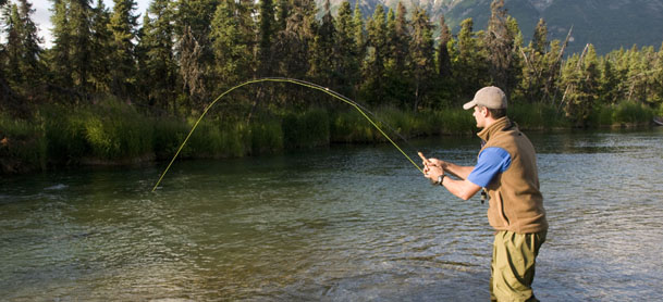 Man flyfishing in lake