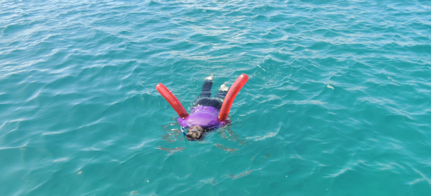 Man using Snorkeling gear and a float