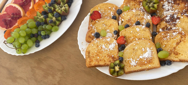 breakfast spread of fruit and french toast with berries