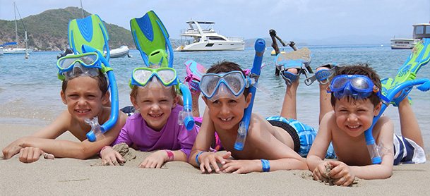Kids laying on beach in snorkel gear