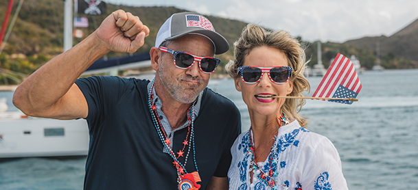 man and women smiling at the camera in patriotic gear