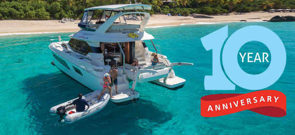 Back view of MarineMax charter with people and anniversary logo