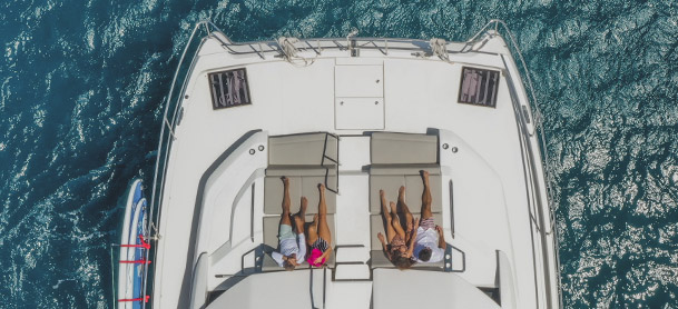 Aerial view of two people on the bow seating of a boat