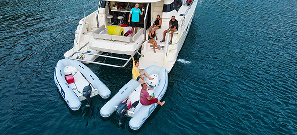 two boats hanging off a catamaran