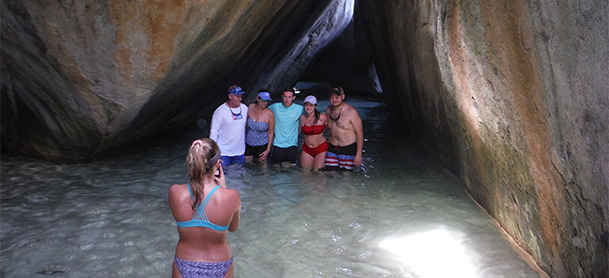 Girl taking a picture of a group in a cave
