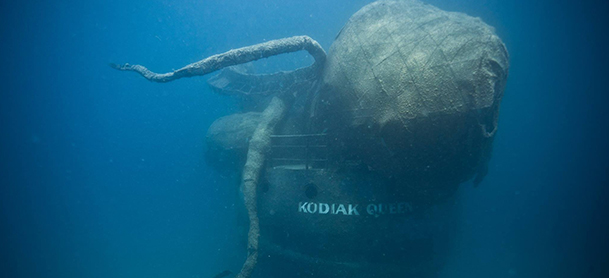 A sunken ship named Kodiak Queen with a large octopus sculpture placed on it