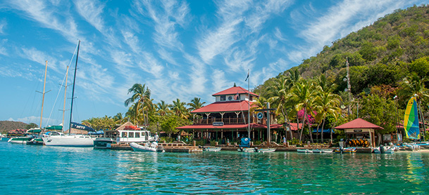 The Bitter End Yacht Club in the British Virgin Islands on a sunny day, with boats docked outside