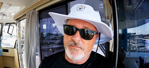 Wandering Hillbilly wearing a hat and sunglasses on his Aquila Power Catamaran