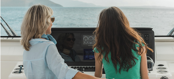 two woman by the helm of the boat