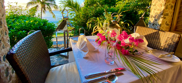 table setting with flowers and water view at the sugar mill
