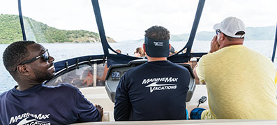 Three men navigating at the helm on a MarineMax vacation 