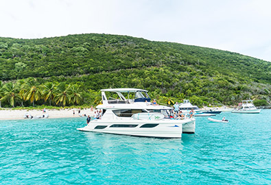 yacht anchored by a beach