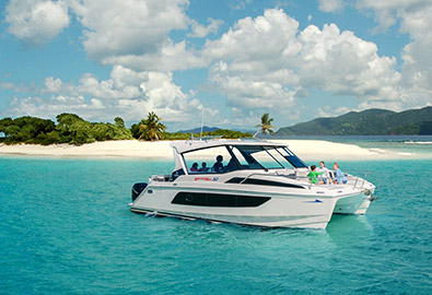People on board of a boat anchored close to an island