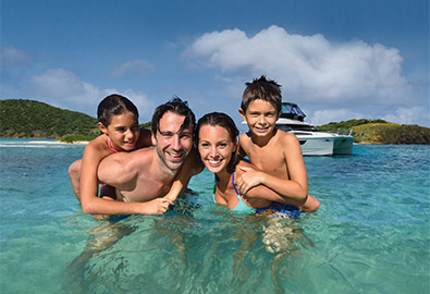 family in the british virgin islands wading in the water