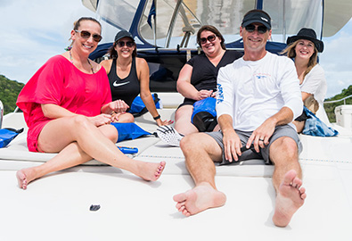 marinemax vacations charter group on bow of boat