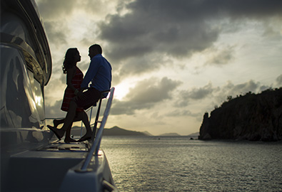 romantic couple on power catamaran charter in the british virgin islands