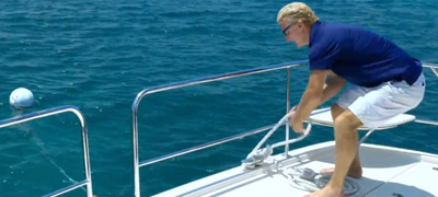 Man removing a mooring ball from water