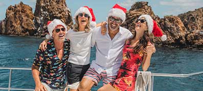 Four people with Santa hats in the BVI