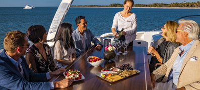 Group of people sitting at table with crew member