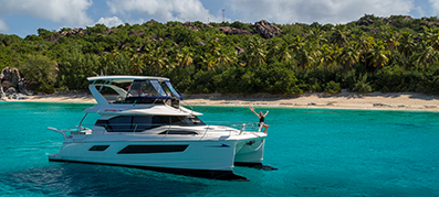 MarineMax charter in the water by a beach