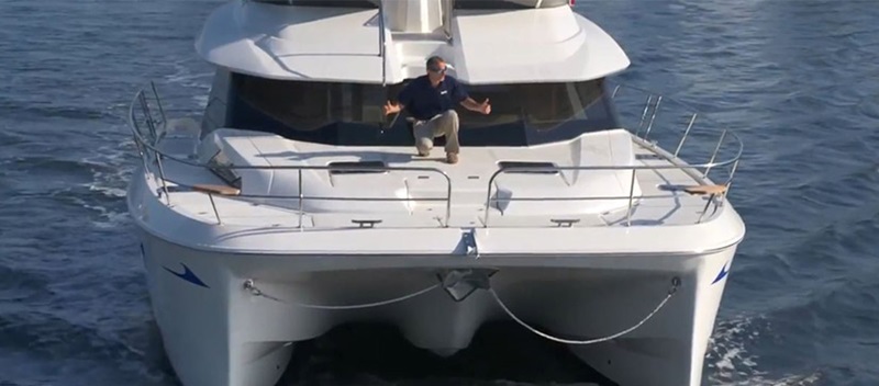 man on the front of a boat on the water