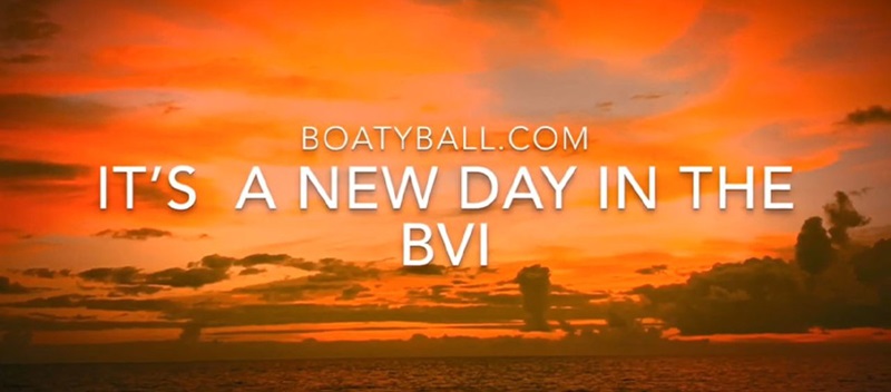 The sun setting on the water in the BVI with the words "BoatyBall.com It's a New Day in the BVI"