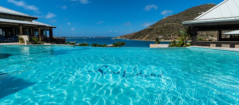 A swimming pool at the Scrub Island Resort and Spa on a sunny day