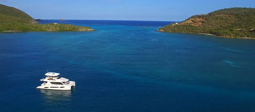 boat sitting in water with islands in the background