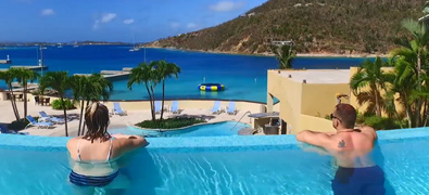 Couple in pool at Scrub Island looking out to ocean.