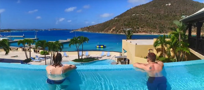 Couple in pool at Scrub Island looking out to ocean.