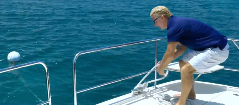 Man removing a mooring ball from water